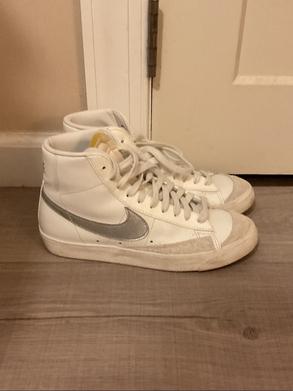 Nike Blazer Women’s White High-Top Sneakers with Silver Swoosh Accent